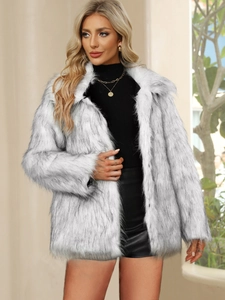 Close-up of white faux fox fur coat texture with plush grey tipped fibers