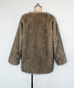 Detail view of the back of a brown faux fur coat with thick and glossy long fibers