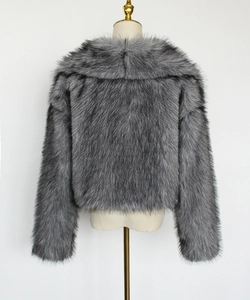 Detailed back view of a grey faux fur jacket showing high-quality plush synthetic fiber