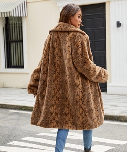 Rear view of long faux fur coat with brown snakeskin pattern for winter street style