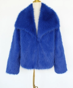 Detailed close-up of premium royal blue faux fur coat with plush texture and wide collar