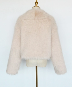 Back view of a soft light pink faux fur short jacket with plush texture on a mannequin