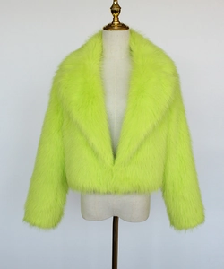 Detail of neon green faux fur jacket showing shaggy texture and wide lapel collar