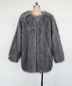 Detailed view of the long gray faux fox fur texture and thick plush material on the coat