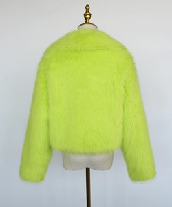 Detail view showing the high-density plush texture of the neon green faux fur cropped jacket