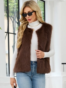 Detailed texture of brown faux fur vest styled with a white turtleneck and sunglasses