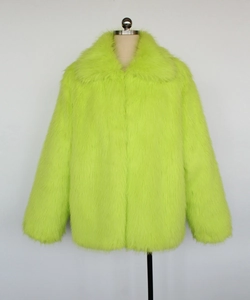 Detail view of the vibrant lime green faux fur jacket with wide lapels and soft texture