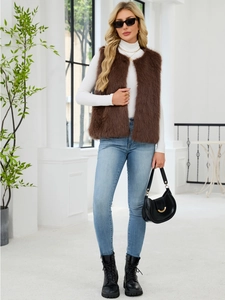 Deep brown faux fur vest styled with white turtleneck and light blue jeans outfit