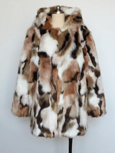 Detail of multi-color faux fur hooded coat showing patchwork texture and plush material