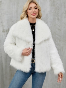Close-up of white faux fur jacket featuring a large collar and thick plush texture