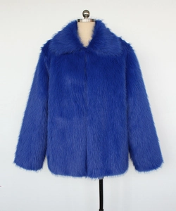Detail of plush bright blue faux fur jacket with wide lapels and thick texture
