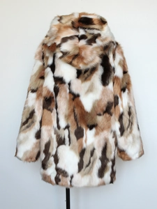 Detail shot of heavy faux fur texture and multi-color patchwork pattern on winter coat