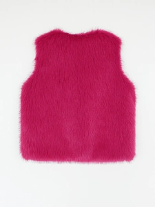 Detailed macro view of the fuchsia faux fur vest showing soft and fluffy long hair texture