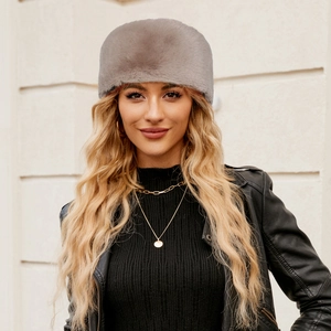 Detailed texture of grey faux fur hat with soft plush fibers and glossy finish