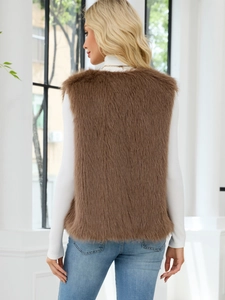 Rear view of long-pile brown faux fur vest styled with white turtleneck and blue jeans