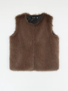 Close-up of brown faux fur vest featuring brand label and soft inner lining texture
