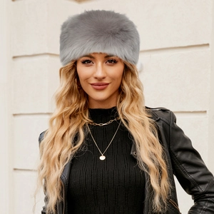 Detail of grey faux fur winter headband worn by a model in a trendy outdoor outfit