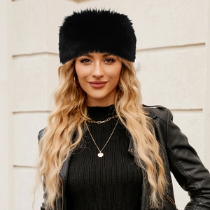 Chic women's black faux fur winter headband and ear warmer worn by a stylish model