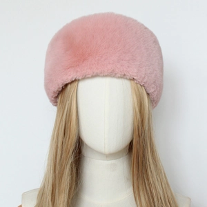Detailed macro view of soft pink faux fur material on this winter thermal headband for women