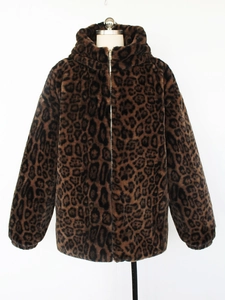Detailed view of leopard print faux fur texture and metal zipper on hooded winter jacket