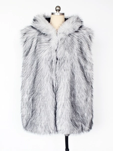 Close-up detail of grey faux fur vest with black tips and oversized hood texture