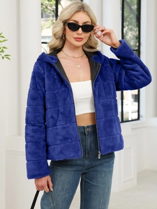 Detail of the navy blue faux fur jacket featuring quilted grid pattern and metal zipper closure