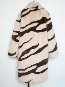 Close-up of zebra pattern faux fox fur texture and heavy plush material on long coat