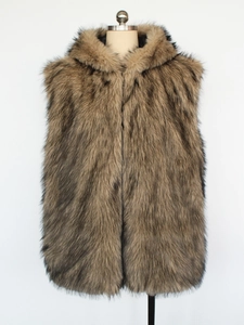 Detail view of the long-haired faux fur texture on the hooded winter vest in brown and grey