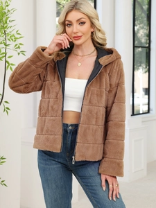 Detail of brown faux rabbit fur jacket featuring square quilted texture and zipper closure