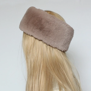 Detailed texture of dusty pink faux fur headband on a golden hair model mannequin