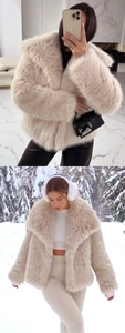 Detail of light beige faux fur jacket with fluffy texture and oversized collar