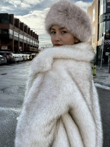 Women's warm faux fur headband and matching coat in elegant light gray for winter