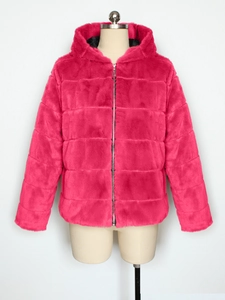 Detail of hooded faux fur jacket in vibrant rose red with zipper and quilted seams