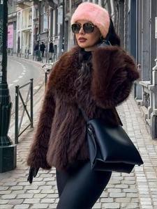 Close-up of fluffy pink faux fur headband styled with sunglasses for winter fashion