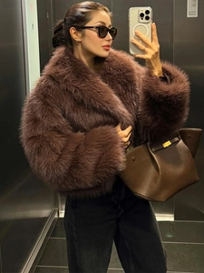 Close-up of thick faux fur jacket with large lapel collar and fluffy texture in dark brown