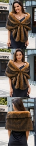 Detailed view of the tiger-stripe faux fur shawl on a model with cross-style fastening