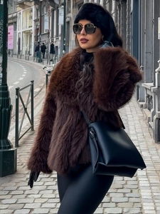 Close-up of the soft texture and fluffy faux fur material on the dark brown winter coat