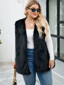 Detailed close-up of a long black faux fur vest with a sleek urban casual street style look