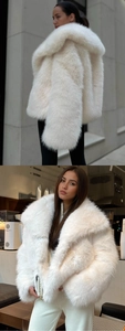 Detail of white faux fur coat featuring a plush texture and wide lapel collar style