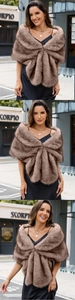 Detail of tan faux fox fur shawl with elegant cross-through design on black dress