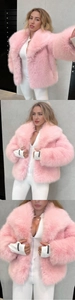 Detail of light pink faux fur jacket with fluffy collar and brand label on cuff