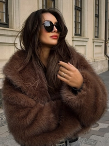 Close-up of fluffy dark brown faux fur coat with dense texture and high-gloss finish