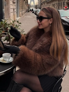 Detail of faux fox fur coat texture with plush wide collar and rich dark brown fibers