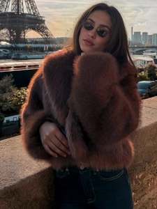 Brown faux fur jacket with wide lapels styled near Eiffel Tower at golden hour
