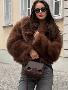 Women's thick faux fur coat in dark brown with shaggy texture and street style