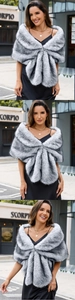 Detailed view of fluffy grey faux fur shawl worn over an elegant black silk evening dress