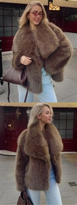 Close-up of fluffy dark brown faux fur coat with oversized lapels and premium texture