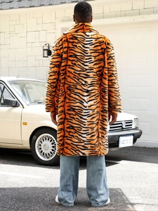 Rear view of a mid-length faux fur coat featuring bold orange and black tiger print stripes