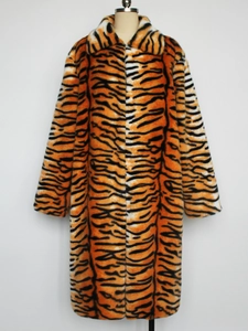 Macro detail of faux fur texture and tiger stripe pattern on men's winter lapel coat
