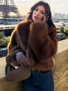 Brown faux fur jacket with fluffy texture shown against the Eiffel Tower in Paris